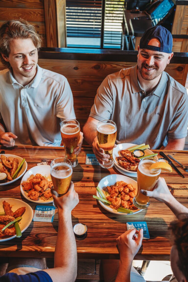 guys cheering with beers at millers ale house